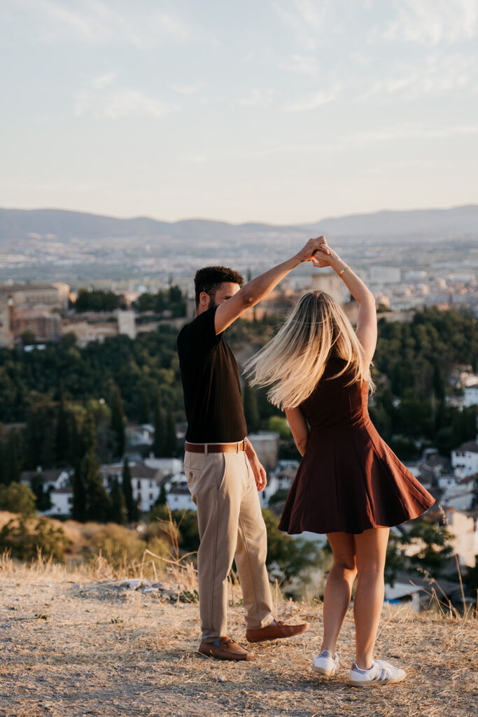 Surprise Proposal in Granada 1 Golden hour twirl at a Granada viewpoint after a surprise proposal